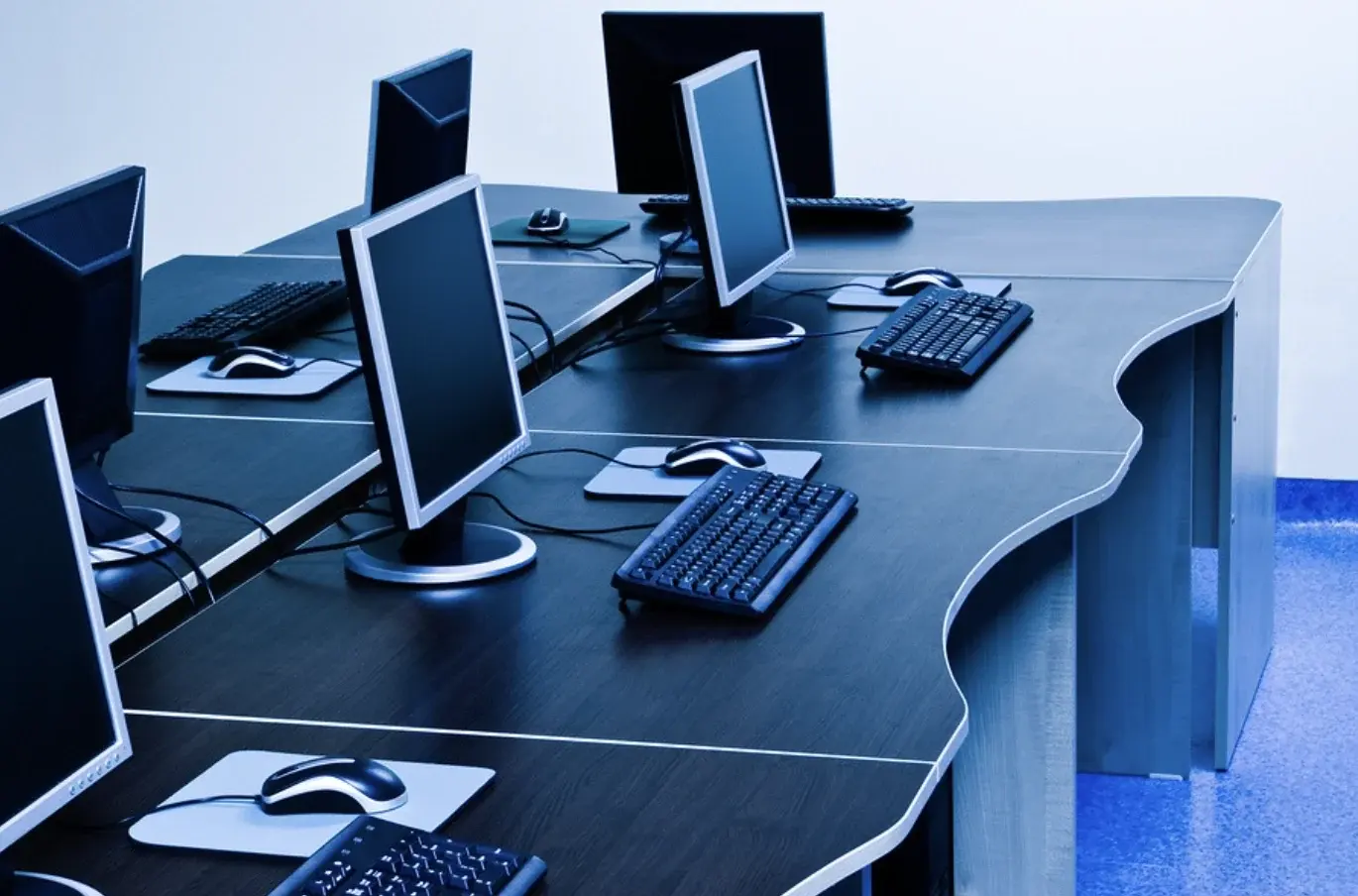 Rows of computers on desks.